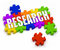 The word Research imposed over colered puzzle pieces