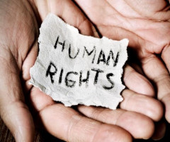"Human Rights" on parchment in a pair of hands